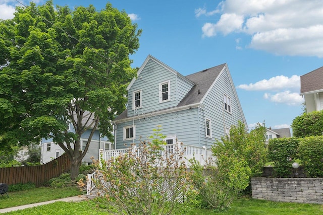 509 S 6th Ave, West Bend, WI 53095 - view of side of property featuring a deck and roof with shingles