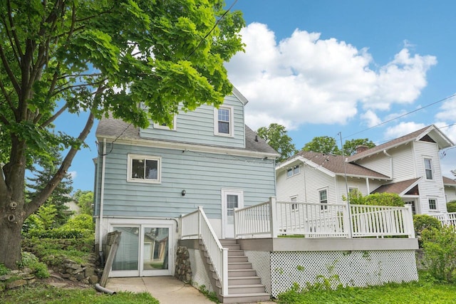 509 S 6th Ave, West Bend, WI 53095 - back of property with stairs, a deck, and a shingled roof