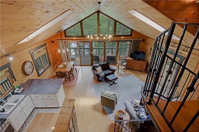 5683N Ham-Holly Dr, Stone Lake, WI 54876 - living area featuring wooden walls, a skylight, wood finished floors, high vaulted ceiling, and wooden ceiling