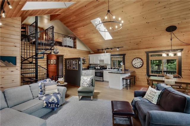 5683N Ham-Holly Dr, Stone Lake, WI 54876 - living area with a skylight, a chandelier, stairs, wooden walls, and light wood-style flooring