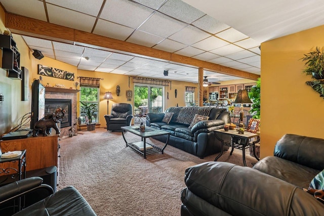 8216 Anna Ave, Wind Lake, WI 53185 - living area featuring carpet floors, a paneled ceiling, a tiled fireplace, and a ceiling fan