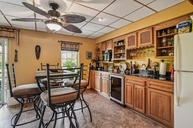 8216 Anna Ave, Wind Lake, WI 53185 - kitchen with wine cooler, open shelves, freestanding refrigerator, dark countertops, and a paneled ceiling