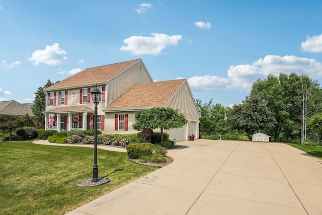 8216 Anna Ave, Wind Lake, WI 53185 - colonial home with concrete driveway, a front yard, a garage, and a storage shed