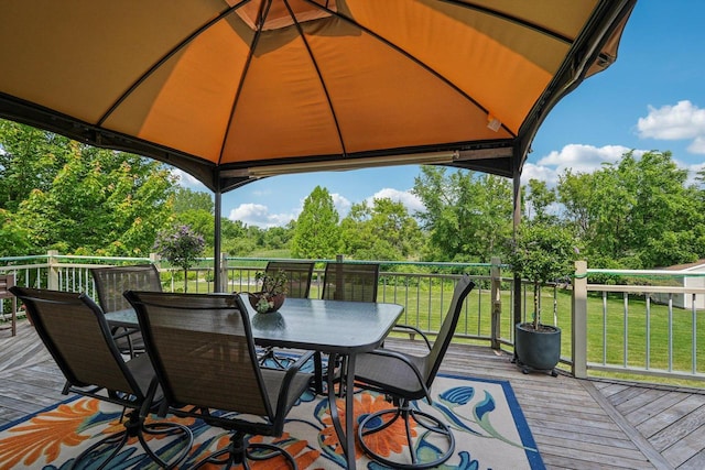 8216 Anna Ave, Wind Lake, WI 53185 - wooden terrace with outdoor dining area, view of wooded area, a yard, and a gazebo