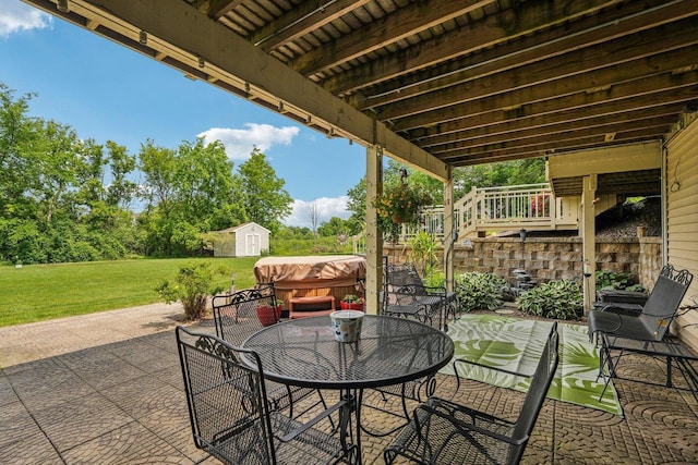 8216 Anna Ave, Wind Lake, WI 53185 - view of patio with a storage unit, a hot tub, outdoor dining area, and stairs