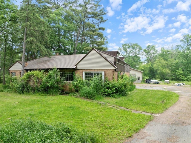 1507 N Peach Ave, Marshfield, WI 54449 - view of side of home with brick siding and a yard