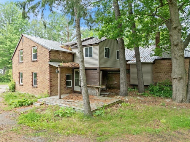 1507 N Peach Ave, Marshfield, WI 54449 - rear view of house with a metal roof and a patio