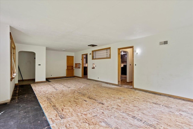 1507 N Peach Ave, Marshfield, WI 54449 - unfurnished living room with baseboards and arched walkways