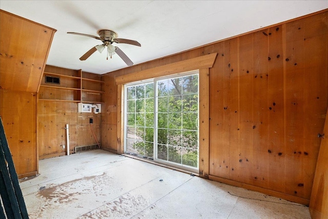 1507 N Peach Ave, Marshfield, WI 54449 - empty room with wood walls and ceiling fan