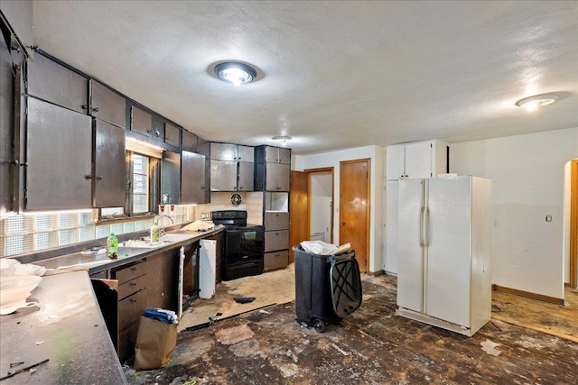 1507 N Peach Ave, Marshfield, WI 54449 - kitchen with freestanding refrigerator and black range with electric cooktop