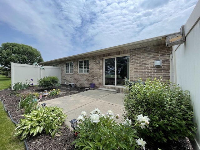 1216 Pond View Cir, De Pere, WI 54115 - rear view of property with brick siding and a patio
