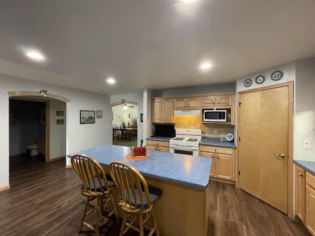 1216 Pond View Cir, De Pere, WI 54115 - kitchen with white range with gas cooktop, stainless steel microwave, dark wood finished floors, a center island, and a kitchen bar