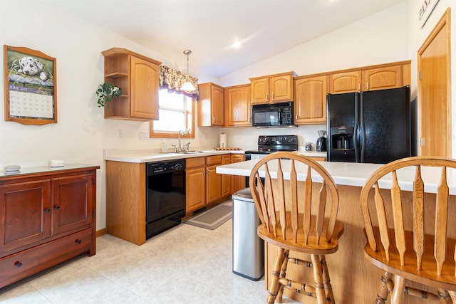 2137 Olde Country Cir, Kaukauna, WI 54130 - kitchen featuring black appliances, light countertops, vaulted ceiling, a breakfast bar area, and decorative light fixtures