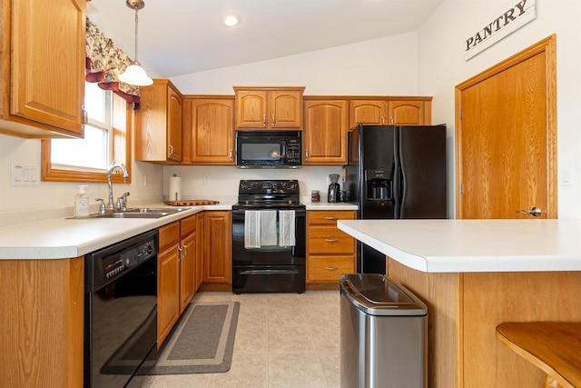 2137 Olde Country Cir, Kaukauna, WI 54130 - kitchen with black appliances, lofted ceiling, light countertops, brown cabinetry, and light tile patterned flooring