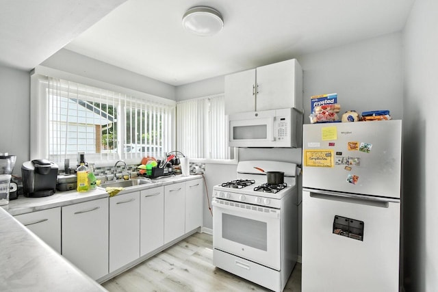5628 W Montana St, Milwaukee, WI 53219 - kitchen with white appliances, light wood-type flooring, white cabinets, and light countertops