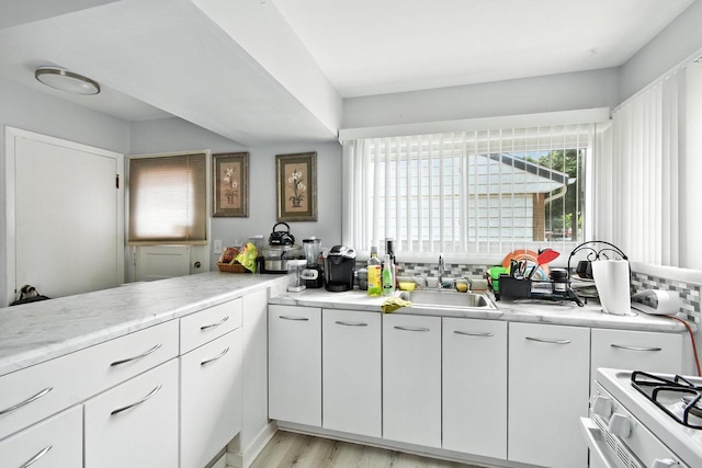 5628 W Montana St, Milwaukee, WI 53219 - kitchen with light countertops, white cabinetry, and light wood-style floors