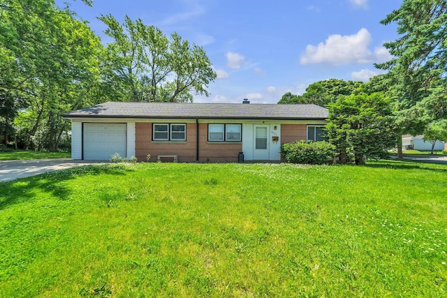 5531 W Stack Dr, Milwaukee, WI 53219 - ranch-style house with driveway, a front lawn, an attached garage, and brick siding