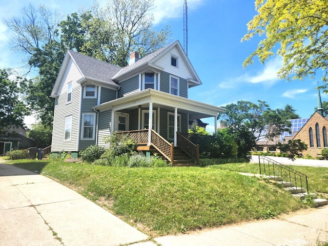1528 Taylor Ave, Racine, WI 53403 - view of front of house with a porch, a chimney, a front yard, and stairway