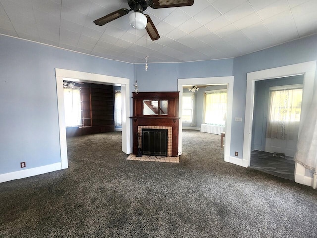 1528 Taylor Ave, Racine, WI 53403 - unfurnished living room featuring ceiling fan, carpet floors, a fireplace, and radiator heating unit