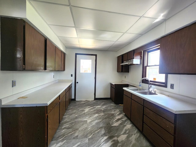 1528 Taylor Ave, Racine, WI 53403 - kitchen featuring wall chimney exhaust hood, plenty of natural light, light countertops, dark brown cabinetry, and a drop ceiling