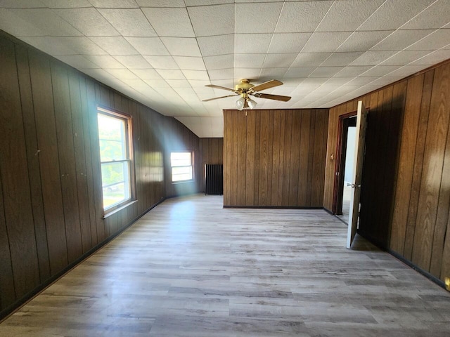 1528 Taylor Ave, Racine, WI 53403 - empty room with wood walls, light wood-style floors, and a ceiling fan