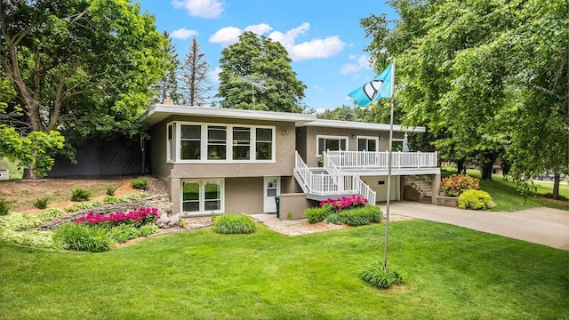 1242 E Edgewood Dr, Appleton, WI 54913 - view of front facade featuring concrete driveway, stairs, stucco siding, a front lawn, and an attached garage