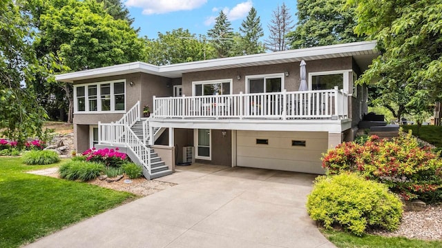 1242 E Edgewood Dr, Appleton, WI 54913 - view of front of home featuring a garage, stucco siding, stairway, concrete driveway, and a front yard