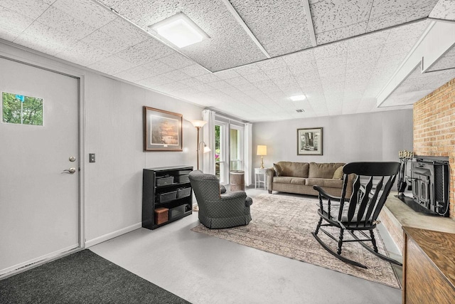 1242 E Edgewood Dr, Appleton, WI 54913 - living room featuring a paneled ceiling and concrete floors