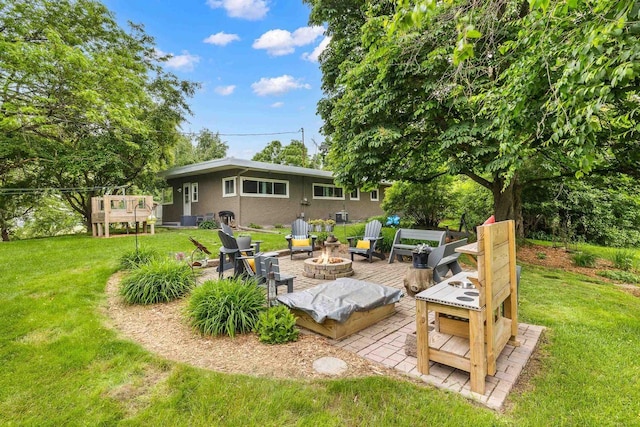 1242 E Edgewood Dr, Appleton, WI 54913 - back of property featuring an outdoor fire pit, stucco siding, a yard, and a deck