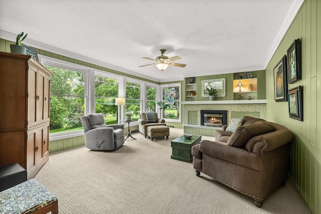 1242 E Edgewood Dr, Appleton, WI 54913 - living area featuring ornamental molding, carpet, a ceiling fan, a textured ceiling, and a fireplace