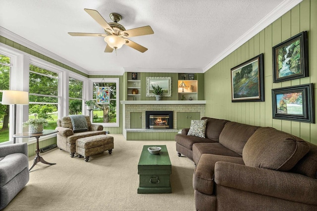 1242 E Edgewood Dr, Appleton, WI 54913 - carpeted living room with crown molding, a ceiling fan, a fireplace, and built in features