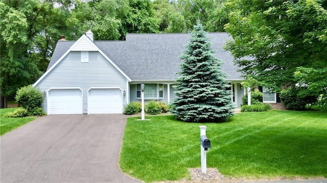 1410 Forest Knoll Ct, Eau Claire, WI 54701 - view of front of home with an attached garage, driveway, a front lawn, a chimney, and a shingled roof