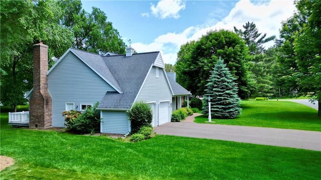 1410 Forest Knoll Ct, Eau Claire, WI 54701 - view of property exterior featuring a chimney, a yard, asphalt driveway, and roof with shingles