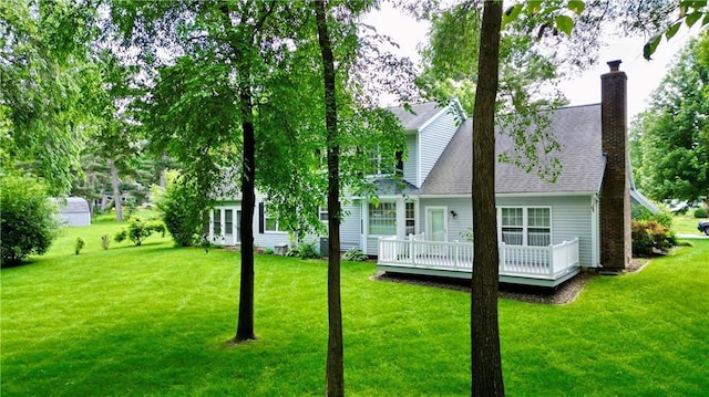 1410 Forest Knoll Ct, Eau Claire, WI 54701 - back of property with a wooden deck, a yard, a chimney, and a shingled roof