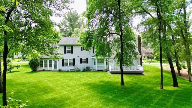 1410 Forest Knoll Ct, Eau Claire, WI 54701 - back of property featuring a yard, a deck, and a chimney