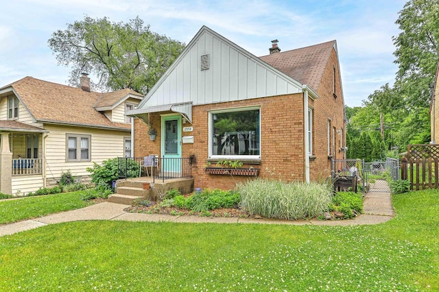 2954 S 48th St, Milwaukee, WI 53219 - bungalow with board and batten siding, brick siding, and a gate