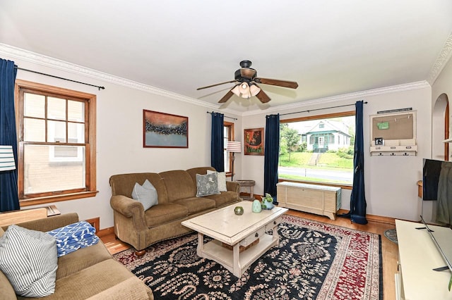2954 S 48th St, Milwaukee, WI 53219 - living room featuring ceiling fan, wood finished floors, crown molding, and arched walkways