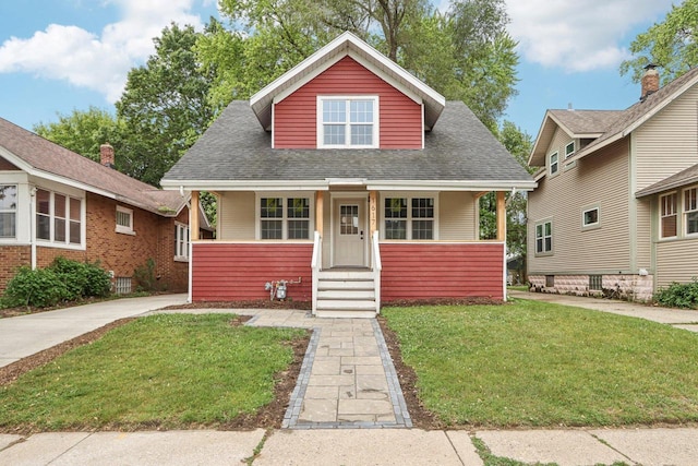1617 69th St, Kenosha, WI 53143 - bungalow with a front lawn, covered porch, and a shingled roof