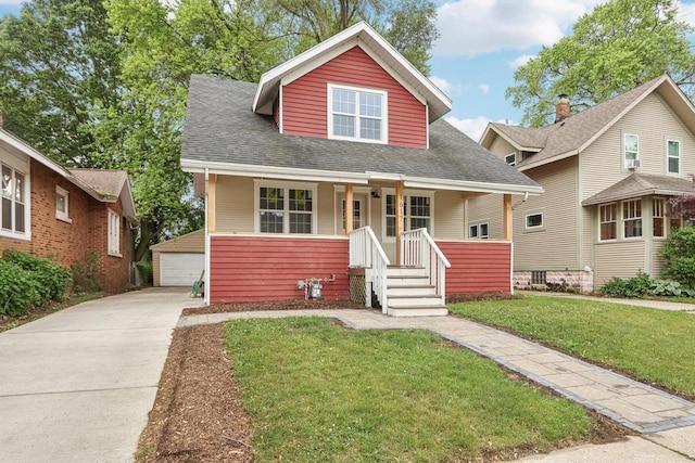 1617 69th St, Kenosha, WI 53143 - bungalow-style house with covered porch, an outbuilding, a garage, a front lawn, and roof with shingles