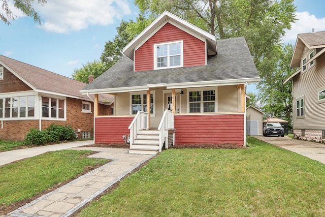 1617 69th St, Kenosha, WI 53143 - bungalow with covered porch, a front lawn, a shingled roof, and concrete driveway