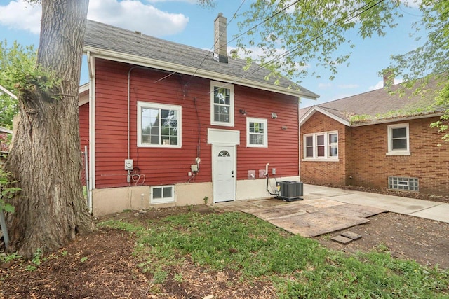 1617 69th St, Kenosha, WI 53143 - rear view of house featuring a chimney and a patio area