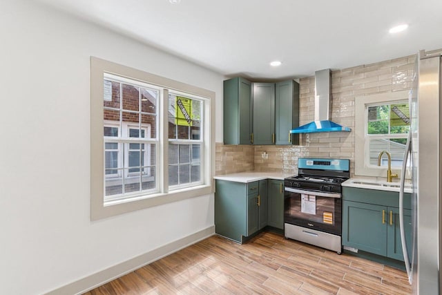 1617 69th St, Kenosha, WI 53143 - kitchen featuring appliances with stainless steel finishes, wall chimney exhaust hood, light countertops, backsplash, and recessed lighting