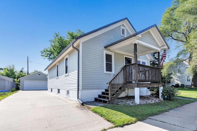517 12th Ave, Green Bay, WI 54303 - view of front of house with covered porch, a detached garage, and an outbuilding