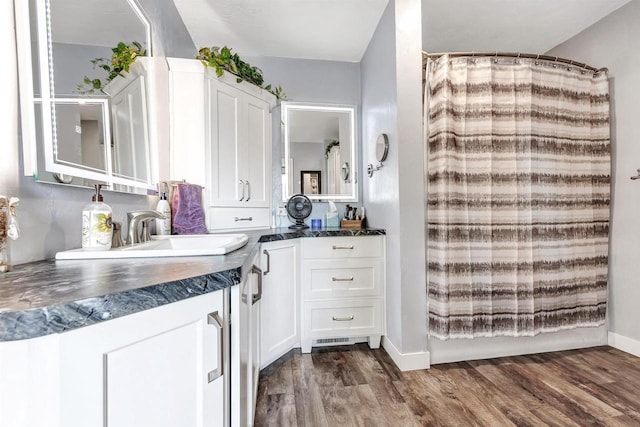 517 12th Ave, Green Bay, WI 54303 - kitchen featuring dark countertops, white cabinets, and dark wood-style flooring