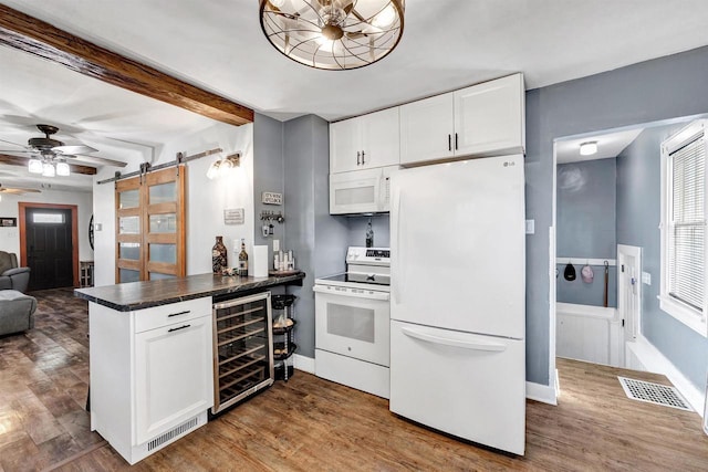 517 12th Ave, Green Bay, WI 54303 - kitchen featuring white appliances, beverage cooler, a barn door, dark countertops, and a peninsula