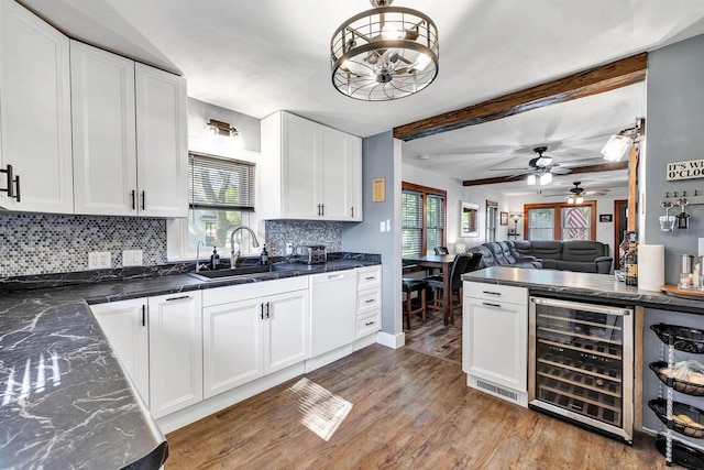 517 12th Ave, Green Bay, WI 54303 - kitchen featuring wine cooler, decorative backsplash, dishwasher, wood finished floors, and white cabinets