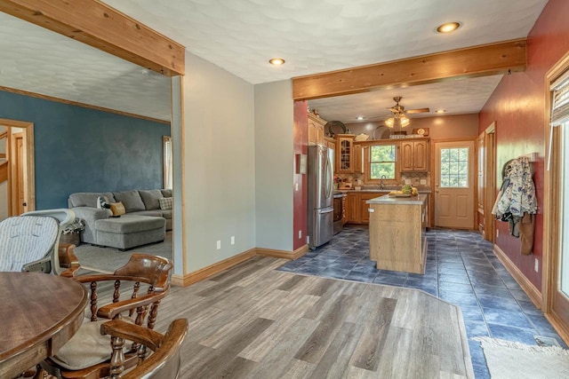 1915 7th St, Monroe, WI 53566 - kitchen featuring freestanding refrigerator, recessed lighting, glass insert cabinets, a center island, and open floor plan