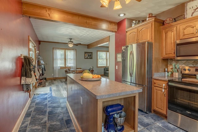 1915 7th St, Monroe, WI 53566 - kitchen with appliances with stainless steel finishes, ceiling fan, a kitchen island, beamed ceiling, and backsplash