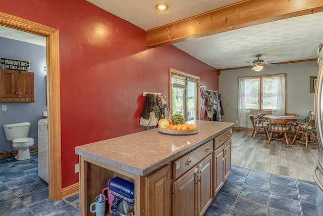 1915 7th St, Monroe, WI 53566 - kitchen featuring beam ceiling, a center island, a ceiling fan, and light countertops
