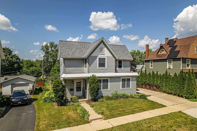 1915 7th St, Monroe, WI 53566 - victorian-style house with a front lawn, a garage, roof with shingles, and driveway